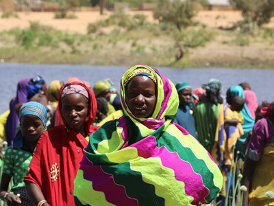 women on river bank