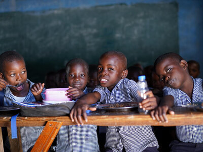 four kids are sitting in their classroom