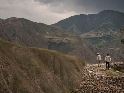 Two WFP staff are walking in the mountain 