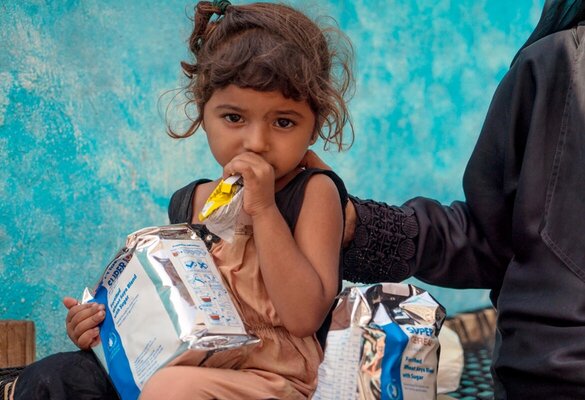 Yemen. Hala, 2, eats supplementary food at a WFP-supported mobile nutrition clinic in Mocha.