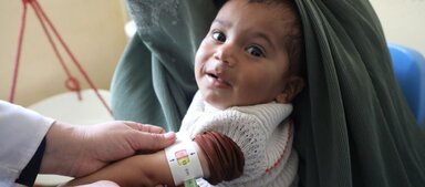 In this photo Samiullah, who is two years old and suffers from malnutrition, is getting measured with a MUAC band at a WFP-supported clinic.