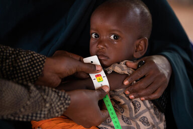 © WFP/Samantha Reinders In this photo Mashallah (2) is held by his mother Dahera (28) while his MUAC is measured and he is assessed for malnutrition.