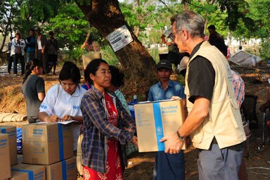 마이클 던포드 WFP 미얀마 사무소장이 네피도 지역에서 지진 생존자에게 WFP 고열량 에너지 비스킷을 나눠주고 있다.