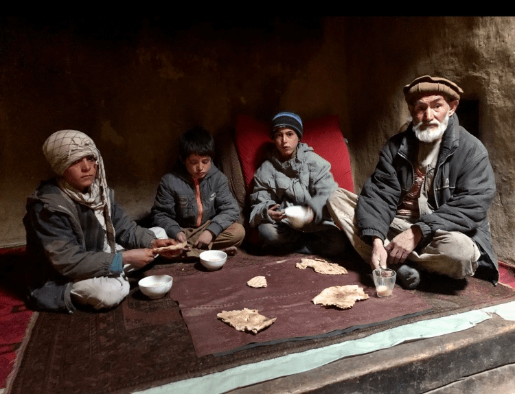 A family take bread and tea with milk, in northeast Afghanistan. Almost 23 million people, more than half the country, don’t know where their next meal is coming from. Photo: WFP/Jon Dumont